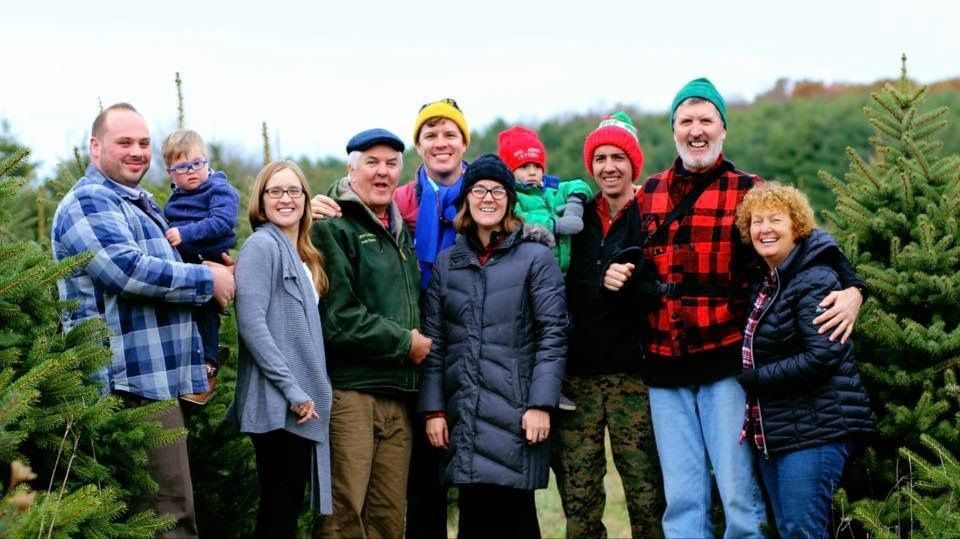 The family gathered among the Christmas trees
