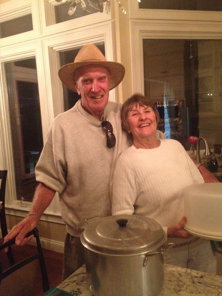 A couple smiling together in the kitchen